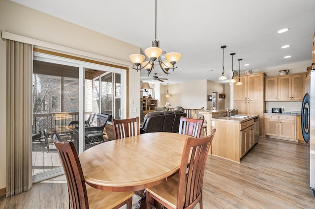 dining area featuring an inviting chandelier, recessed lighting, and light wood finished floors