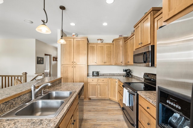 kitchen featuring recessed lighting, a sink, light brown cabinetry, stainless steel appliances, and light wood-type flooring