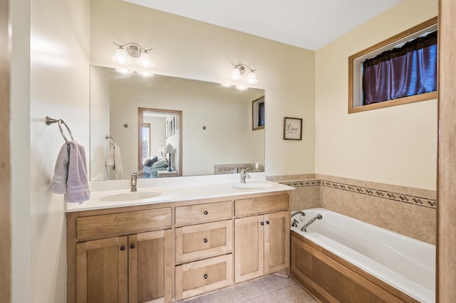 bathroom featuring a sink, a garden tub, double vanity, and tile patterned floors