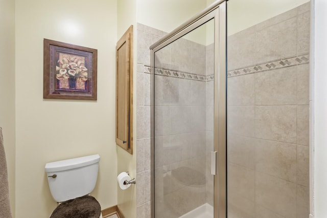 full bath with toilet and a shower stall