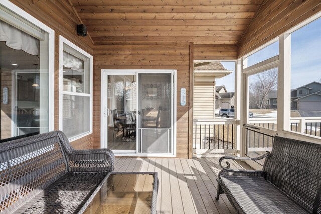 sunroom / solarium featuring lofted ceiling and wooden ceiling