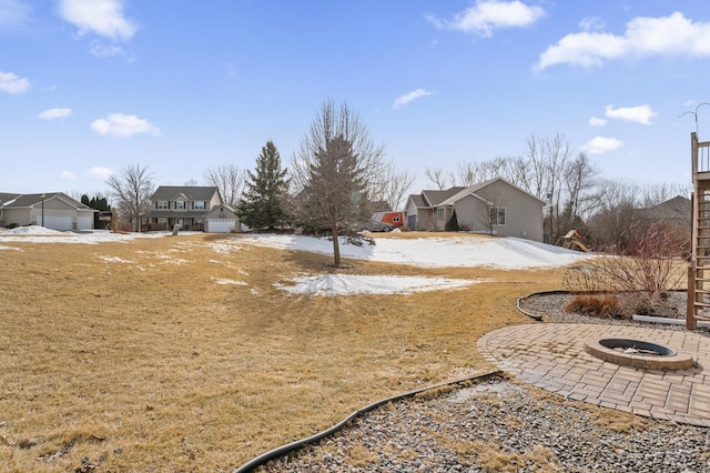 yard covered in snow featuring an outdoor fire pit