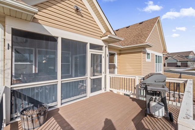 wooden deck with a sunroom