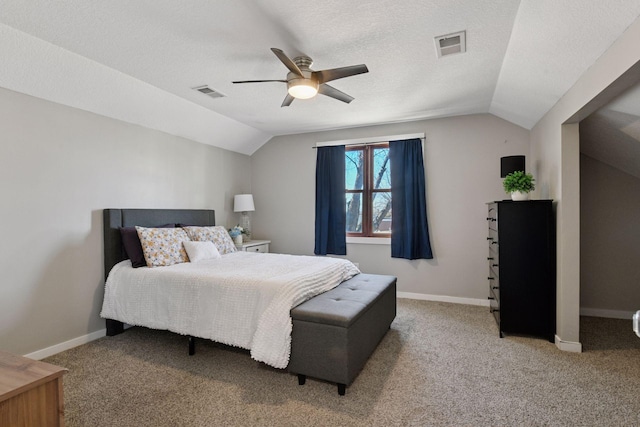 bedroom with visible vents, lofted ceiling, and light carpet