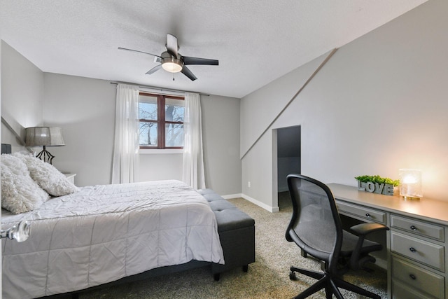 carpeted bedroom with a ceiling fan, baseboards, and a textured ceiling