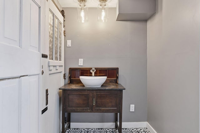 bathroom with vanity and baseboards