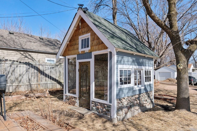 view of outdoor structure featuring an outdoor structure and fence