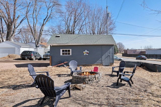 exterior space with an outbuilding and a fire pit