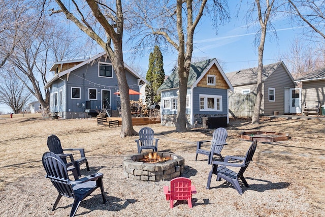 view of yard with an outdoor structure and an outdoor fire pit