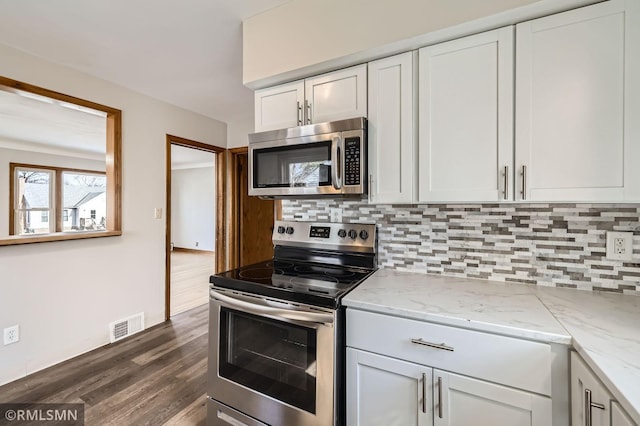 kitchen featuring white cabinetry, visible vents, backsplash, and stainless steel appliances