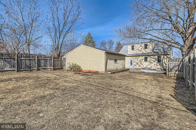 back of house featuring a fenced backyard