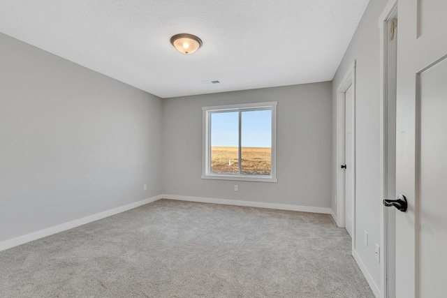 unfurnished bedroom with a textured ceiling, baseboards, and carpet floors