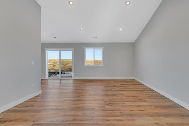 empty room with recessed lighting, visible vents, baseboards, and light wood finished floors