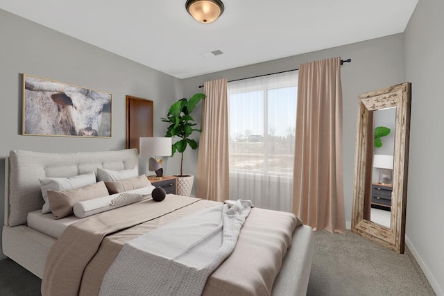 bedroom featuring baseboards, visible vents, and light carpet