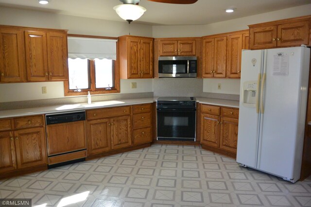 5501 70th St, Glencoe, MN 55336 - kitchen featuring white fridge with ice dispenser, stainless steel microwave, paneled dishwasher, stove, and brown cabinetry