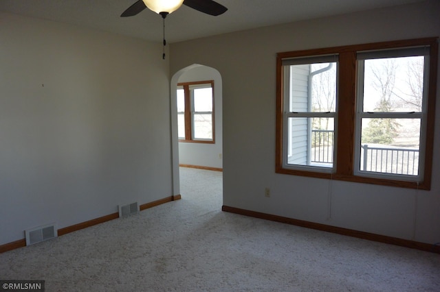 5501 70th St, Glencoe, MN 55336 - carpeted empty room with arched walkways, a ceiling fan, and baseboards
