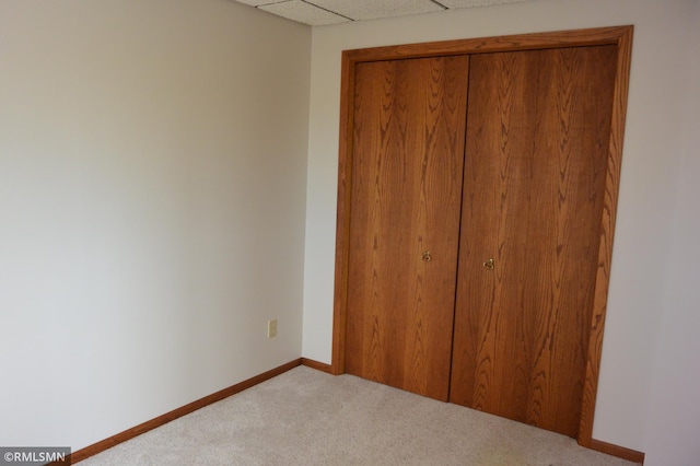 5501 70th St, Glencoe, MN 55336 - unfurnished bedroom featuring carpet floors, baseboards, a closet, and a paneled ceiling