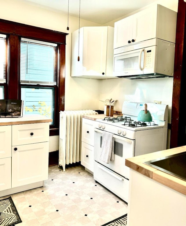 kitchen with white cabinetry, white appliances, radiator, and light floors