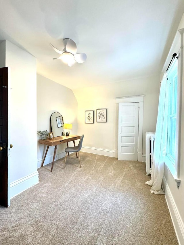 office space featuring baseboards, carpet floors, ceiling fan, and radiator heating unit