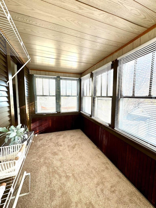 unfurnished sunroom featuring wooden ceiling