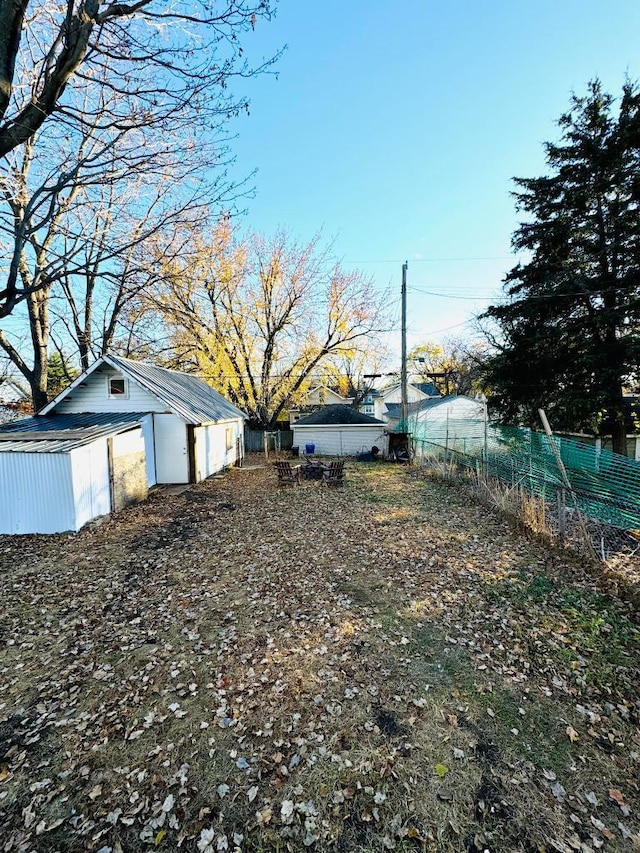 view of yard featuring an outbuilding and fence