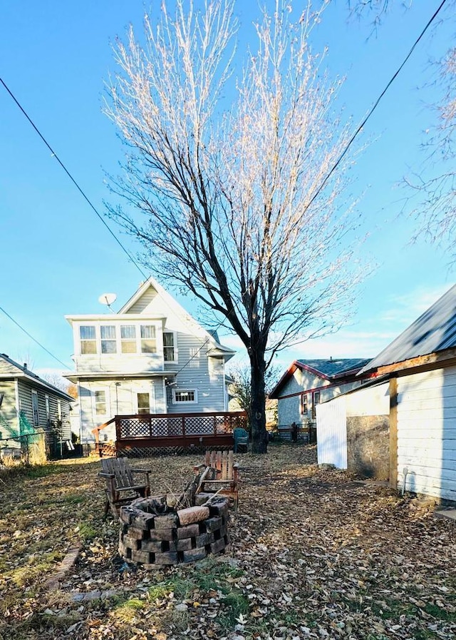 rear view of house featuring a fire pit