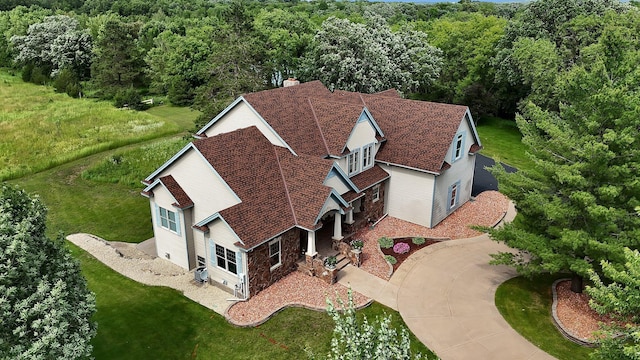 bird's eye view with a wooded view