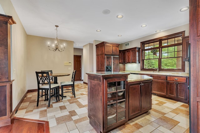 kitchen featuring visible vents, recessed lighting, baseboards, and paneled refrigerator