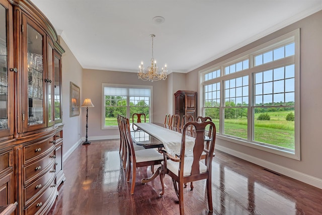 dining space with dark wood-style floors, baseboards, ornamental molding, and a chandelier