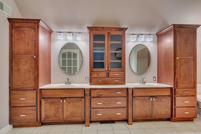 bathroom featuring double vanity, visible vents, tile patterned floors, and a sink