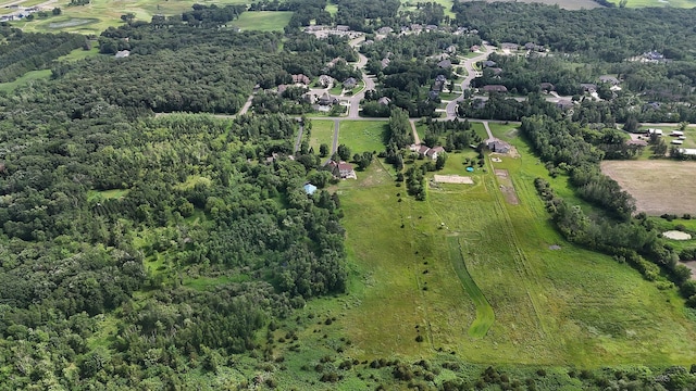 birds eye view of property with a wooded view