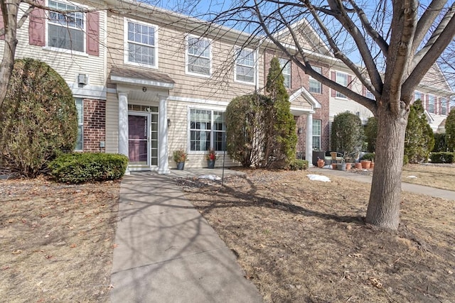 townhome / multi-family property with brick siding