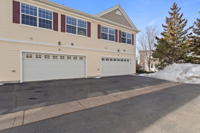 view of front of house with aphalt driveway and an attached garage