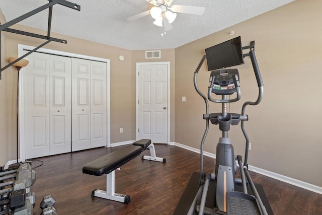 workout room with wood finished floors, a ceiling fan, visible vents, and a textured ceiling