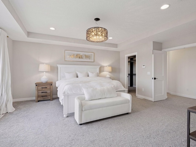16419 Kiska St NE, Ham Lake, MN 55304 - bedroom with light colored carpet, recessed lighting, a tray ceiling, and a chandelier