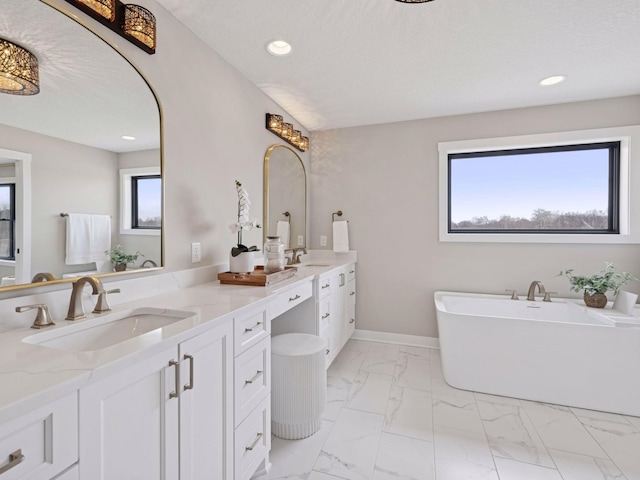 16419 Kiska St NE, Ham Lake, MN 55304 - full bathroom featuring double vanity, a freestanding bath, marble look tile flooring, and recessed lighting