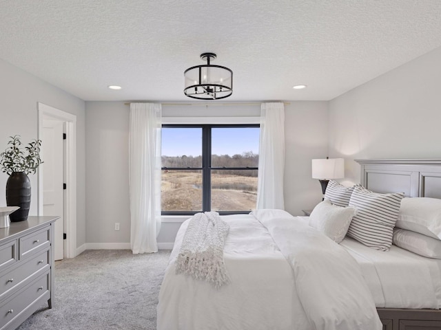 16419 Kiska St NE, Ham Lake, MN 55304 - bedroom featuring light carpet, a chandelier, a textured ceiling, and recessed lighting