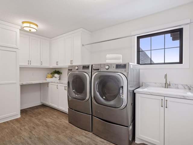 16419 Kiska St NE, Ham Lake, MN 55304 - washroom featuring washing machine and dryer, cabinet space, and wood finished floors