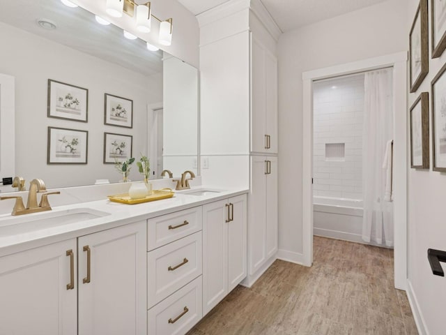 16419 Kiska St NE, Ham Lake, MN 55304 - full bath with double vanity, wood finished floors, and shower / washtub combination