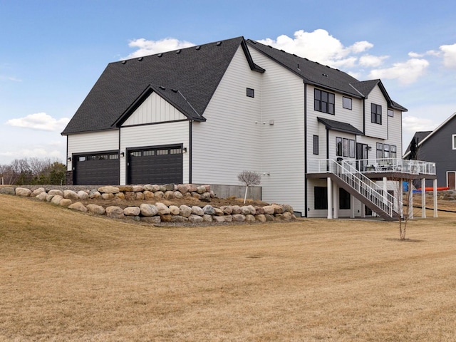 16419 Kiska St NE, Ham Lake, MN 55304 - view of side of property with stairs, a lawn, a wooden deck, board and batten siding, and a shingled roof