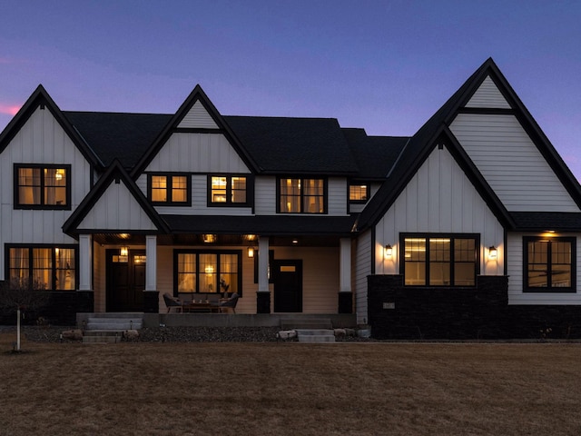 16419 Kiska St NE, Ham Lake, MN 55304 - back of house at dusk with board and batten siding, covered porch, and roof with shingles