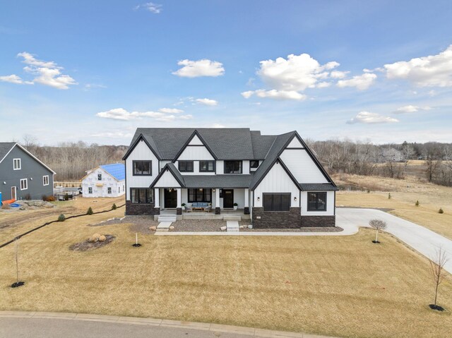 16419 Kiska St NE, Ham Lake, MN 55304 - modern inspired farmhouse with a porch, board and batten siding, a front yard, concrete driveway, and a shingled roof