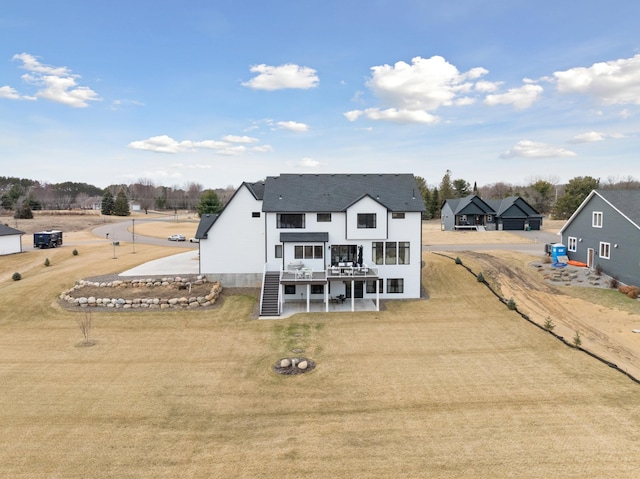16419 Kiska St NE, Ham Lake, MN 55304 - rear view of house featuring a deck and a lawn