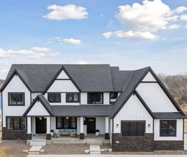 16419 Kiska St NE, Ham Lake, MN 55304 - modern farmhouse style home featuring roof with shingles, board and batten siding, a porch, and stone siding
