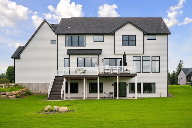 16419 Kiska St NE, Ham Lake, MN 55304 - rear view of house featuring stairs, a deck, a lawn, and a patio area