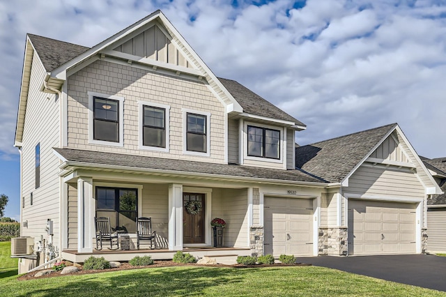 view of front facade featuring a porch, stone siding, aphalt driveway, central air condition unit, and board and batten siding