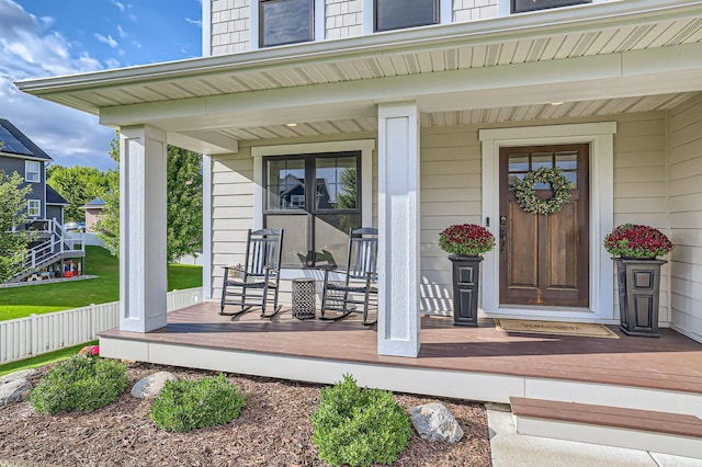 view of exterior entry with a porch