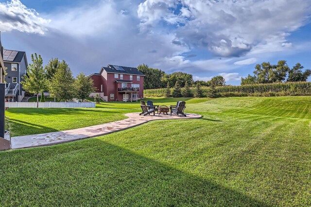 surrounding community with a patio, a yard, and a fire pit