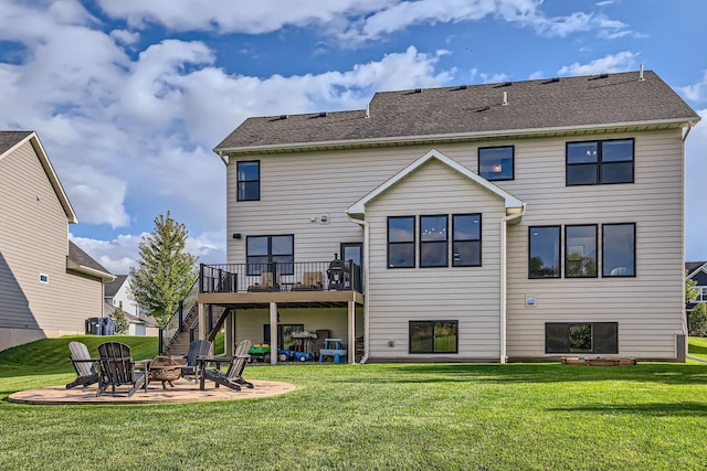 back of property with an outdoor fire pit, stairs, a yard, a deck, and a patio area