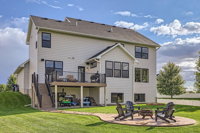 rear view of property featuring an outdoor fire pit, stairs, a lawn, a deck, and a patio area